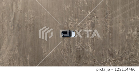 White electric car driving on dirt road, White electric car vehicle passing through dirt road, White electric vehicle car offroad 4wd, 4x4 off road ev car. White electric car driving on dirt road, White electric car vehicle passing through dirt road, White electric vehicle car offroad 4wd, 4x4 off road ev car. 125114460