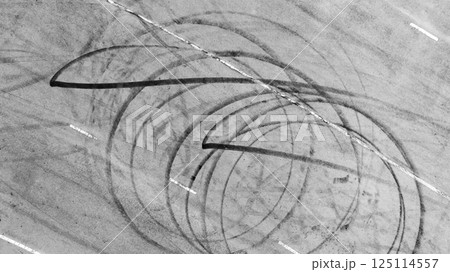 Top view car tire marks on asphalt road race track, Abstract car tire marks on asphalt road race track texture and background, Black car tire marks on race track texture and background. 125114557