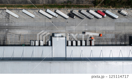 Aerial top view semi truck cargo trailer at logistic park warehouse goods, Distribution warehouse shipping supply chain, Business transportation logistic freight shipping cargo by semi truck cargo Aerial top view semi truck cargo trailer at logistic park warehouse goods, Distribution warehouse shipping supply chain, Business transportation logistic freight shipping cargo by semi truck cargo 125114717