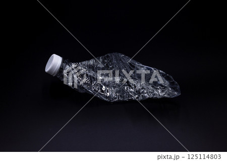 Crushed plastic water bottle on black background, Save the environment, Twisted plastic water bottle on black background. Crushed plastic water bottle on black background, Save the environment, Twisted plastic water bottle on black background. 125114803