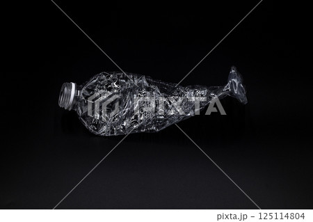 Crushed plastic water bottle on black background, Save the environment, Twisted plastic water bottle on black background. 125114804