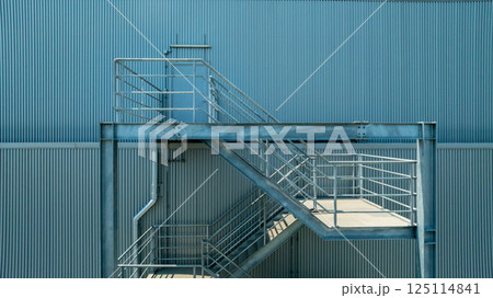 Fire Escape stairs on the building wall in factory building, Industrial elements and fire escape stairs, Metal outdoor industrial stairs ire escape stairs. Fire Escape stairs on the building wall in factory building, Industrial elements and fire escape stairs, Metal outdoor industrial stairs ire escape stairs. 125114841