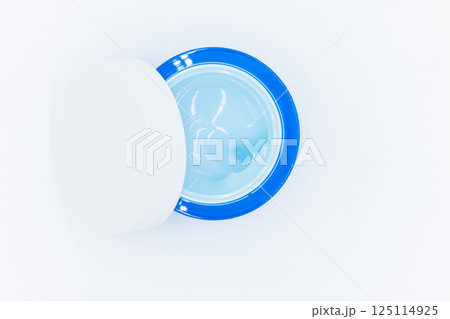 Top view blue water gel cosmetic serum in blue container, Liquid gel moisturizer, Blue gel serum texture make up and cosmetic texture background, skincare product and beauty cream. 125114925