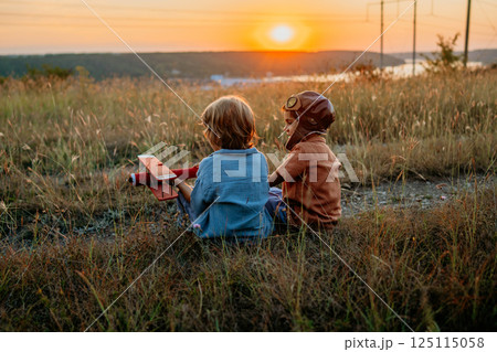 Friends brothers, boys plays, talks aviation. Handmade wooden vintage plane toy 125115058