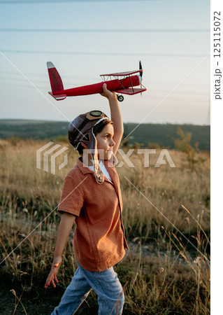 Happy handsome 5 Years Old Child Boy Running With Wooden Vintage Airplane. Kid Happy handsome 5 Years Old Child Boy Running With Wooden Vintage Airplane. Kid 125115072