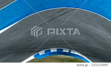 Asphalt race track curve with tire mark, Race track for auto racing with car tire skid mark, Car race track asphalt and curve track circuit, Empty curve racetrack car tire mark 125115097