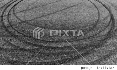 Black car tire marks on asphalt car race track circuit, Car tire mark on speed track texture and background, Abstract car tire mark on race track, Top view car tire track. 125115187
