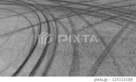 Black car tire marks on asphalt car race track circuit, Car tire mark on speed track texture and background, Abstract car tire mark on race track, Top view car tire track. Black car tire marks on asphalt car race track circuit, Car tire mark on speed track texture and background, Abstract car tire mark on race track, Top view car tire track. 125115188