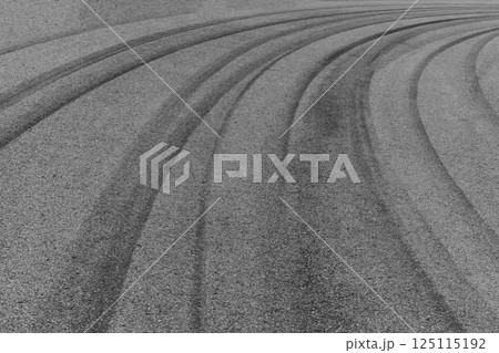 Car tire mark on race track, Abstract black car tire mark on race track, Abstract texture background car tire mark skid mark on asphalt circuit, Tire track on road race speed track circuit. 125115192