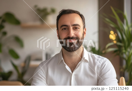 Person in white collared shirt in bright indoor space with green plants and blurred bookshelf background, serene and professional atmosphere with natural light 125115240