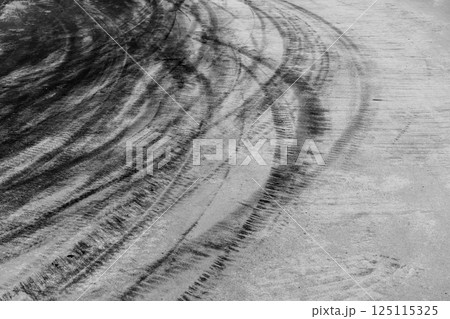 Car tire mark on race track, Abstract black car tire mark on race track, Abstract texture background car tire mark skid mark on asphalt circuit, Tire track on road race speed track circuit. Car tire mark on race track, Abstract black car tire mark on race track, Abstract texture background car tire mark skid mark on asphalt circuit, Tire track on road race speed track circuit. 125115325