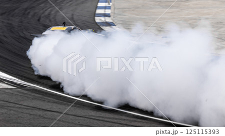 Motorsport car drift on asphalt race track with lot of smoke from burning wheel tires rubber, Drift motor sport car drift race, Professional driver drift car on asphalt race track, Car motion blurred. 125115393