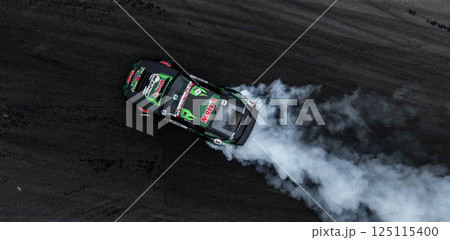 Car drift on asphalt race track with lot of smoke from burning wheel tires rubber, Drift motorsport car drift race, Professional driver drift car on asphalt race track, Car motion blurred motorsport. 125115400