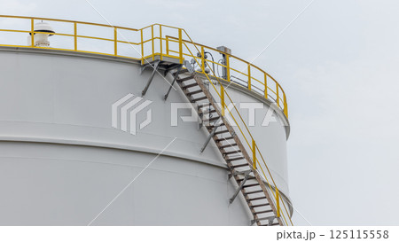 White oil storage tank with blue sky background at oil and gas refinery industrial zone, Business industrial factory oil and gas refinery, Crude oil and gas storage tank business logistic and White oil storage tank with blue sky background at oil and gas refinery industrial zone, Business industrial factory oil and gas refinery, Crude oil and gas storage tank business logistic and 125115558
