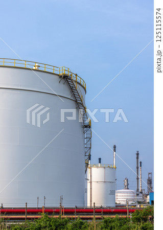 Oil storage tank blue sky background at oil and gas refinery industrial zone, Business industrial factory oil and gas refinery, Crude oil and gas storage tank business logistic and transportation. Oil storage tank blue sky background at oil and gas refinery industrial zone, Business industrial factory oil and gas refinery, Crude oil and gas storage tank business logistic and transportation. 125115574