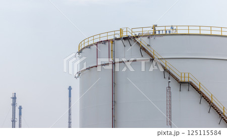 White oil storage tank with blue sky background at oil and gas refinery industrial zone, Business industrial factory oil and gas refinery, Crude oil and gas storage tank business logistic and White oil storage tank with blue sky background at oil and gas refinery industrial zone, Business industrial factory oil and gas refinery, Crude oil and gas storage tank business logistic and 125115584