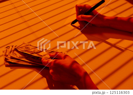 Counting Dollar Banknotes and Writing Financial Notes. Counting Dollar Banknotes and Writing Financial Notes. 125116303