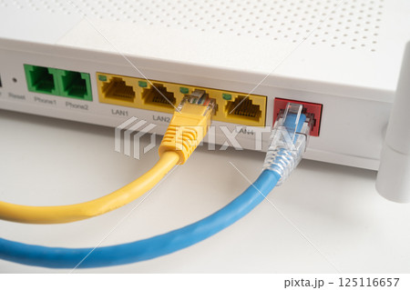 Ethernet cable with wireless router connect to internet service provider internet network. Ethernet cable with wireless router connect to internet service provider internet network. 125116657