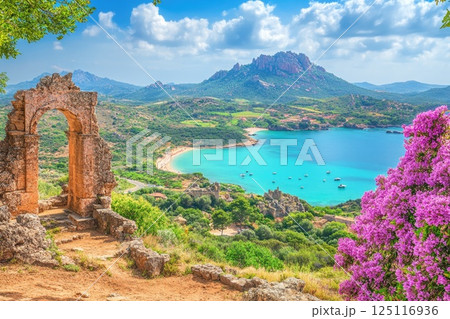 Explore the stunning Sardinian coastline with ancient Nuragic ruins under a bright sky 125116936