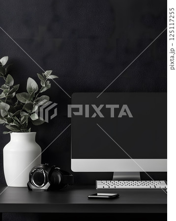 Computer stands on table with plants. dark background. Front view. Computer mockup for design 125117255
