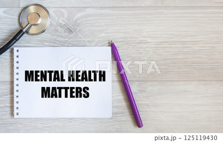 The symbol "Mental health matters." The words "Mental health" are written on a notebook. The symbol "Mental health matters." The words "Mental health" are written on a notebook. 125119430