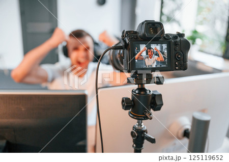 Process of recording. Young man playing and streaming the first person shooter game Process of recording. Young man playing and streaming the first person shooter game 125119652