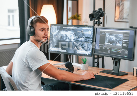 Process of recording. Young man playing and streaming the first person shooter game Process of recording. Young man playing and streaming the first person shooter game 125119653