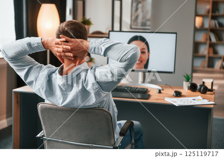 Retouching portrait of woman. Designer is sitting by the computer and using graphics tablet with stylus Retouching portrait of woman. Designer is sitting by the computer and using graphics tablet with stylus 125119717