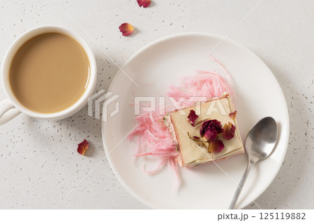 Tasty trendy breakfast with handicraft coffee and pink chocolate with airy filling white and pink pismaniye. Dessert with Cotton candy. View from above. Tasty trendy breakfast with handicraft coffee and pink chocolate with airy filling white and pink pismaniye. Dessert with Cotton candy. View from above. 125119882