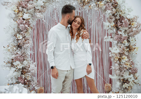 A young groom with his bride in a white dress. Wedding conception 125120010