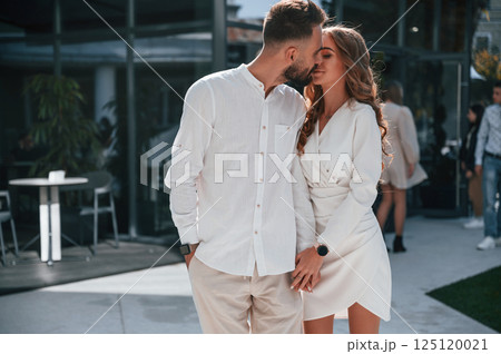Beautiful young couple together outdoors on the street Beautiful young couple together outdoors on the street 125120021