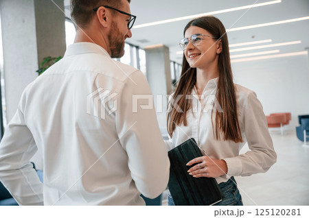 Talking, making a deal. Man and woman in formal clothes are working together indoors 125120281