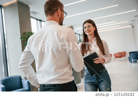Talking, making a deal. Man and woman in formal clothes are working together indoors 125120282