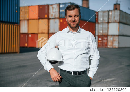 Beautiful portrait. Male worker is on the location with containers Beautiful portrait. Male worker is on the location with containers 125120862