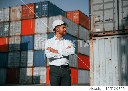 Beautiful portrait. Male worker is on the location with containers Beautiful portrait. Male worker is on the location with containers 125120863