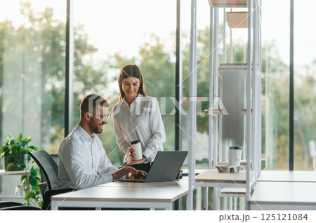 Sharing ideas. Man and woman are working in the modern office together 125121084