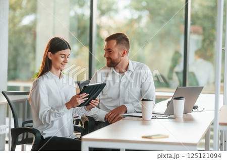 Sharing ideas. Man and woman are working in the modern office together 125121094