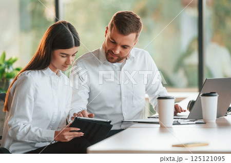 Sharing ideas. Man and woman are working in the modern office together 125121095