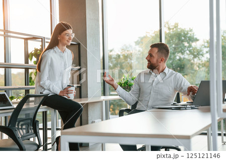 Having a conversation. Man and woman are working in the modern office together Having a conversation. Man and woman are working in the modern office together 125121146