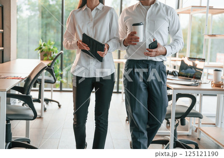 Front view. Man and woman are working in the modern office together Front view. Man and woman are working in the modern office together 125121190