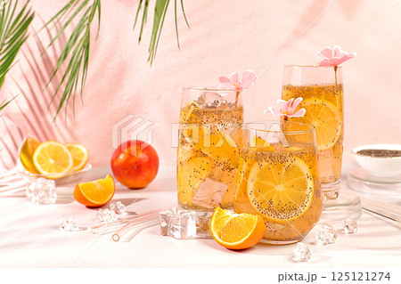 Detox diet and weight loss concept. Diet vegan cocktail with chia seeds, orange, lime, violet and ice. Summer party and healthy lifestyle advertisement. Summer banner and screen template. Detox diet and weight loss concept. Diet vegan cocktail with chia seeds, orange, lime, violet and ice. Summer party and healthy lifestyle advertisement. Summer banner and screen template. 125121274