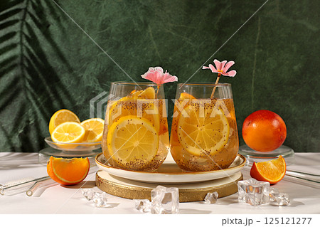 Diet vegan cocktail with chia seeds, orange, lime, violet and ice.Detox diet and weight loss concept. Summer party and healthy lifestyle advertisement. Summer banner and screen template. Diet vegan cocktail with chia seeds, orange, lime, violet and ice.Detox diet and weight loss concept. Summer party and healthy lifestyle advertisement. Summer banner and screen template. 125121277