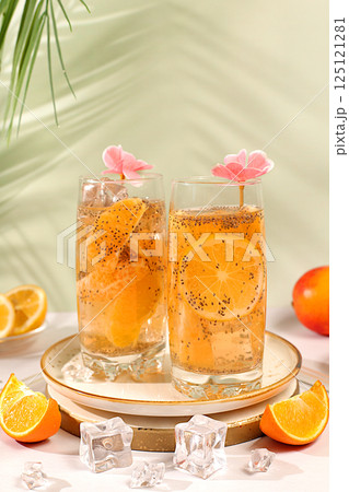 Detox diet and weight loss concept. Diet vegan cocktail with chia seeds, orange, lime, violet and ice. Summer party and healthy lifestyle advertisement. Summer banner and screen template. 125121281