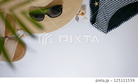 Summer travel vacation mood layout lifestyle spa wellness concept with beach accessories and copy space. Top view flat lay background, including straw hat, sunglasses, swimsuit, seashells and pebbles Summer travel vacation mood layout lifestyle spa wellness concept with beach accessories and copy space. Top view flat lay background, including straw hat, sunglasses, swimsuit, seashells and pebbles 125121539