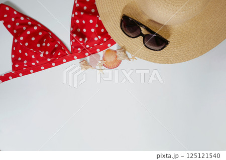 Summer travel vacation mood layout lifestyle spa wellness concept with beach accessories and copy space. Top view flat lay background, including straw hat, sunglasses, swimsuit, seashells and pebbles Summer travel vacation mood layout lifestyle spa wellness concept with beach accessories and copy space. Top view flat lay background, including straw hat, sunglasses, swimsuit, seashells and pebbles 125121540