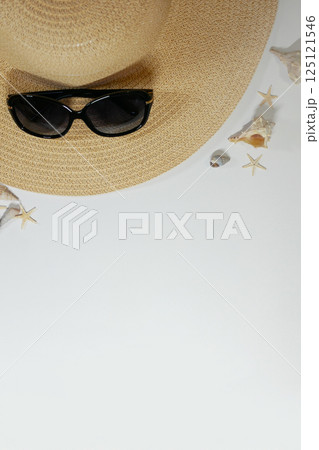 Summer travel vacation mood layout lifestyle spa or wellness concept with beach accessories and copy space. Top view flat lay background, including straw hat, sunglasses, seashells and pebbles Summer travel vacation mood layout lifestyle spa or wellness concept with beach accessories and copy space. Top view flat lay background, including straw hat, sunglasses, seashells and pebbles 125121546
