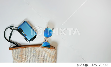Summer travel vacation mood layout lifestyle spa or wellness concept with beach accessories and copy space. Top view flat lay background, including beach bag, sunglasses, photo camera Summer travel vacation mood layout lifestyle spa or wellness concept with beach accessories and copy space. Top view flat lay background, including beach bag, sunglasses, photo camera 125121548
