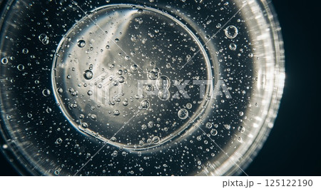Transparent gel droplet with air bubbles under soft diffused light in extreme close-up 125122190