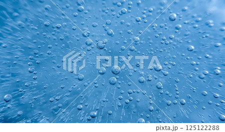 Frozen ice with trapped air bubbles in soft blue tones 125122288