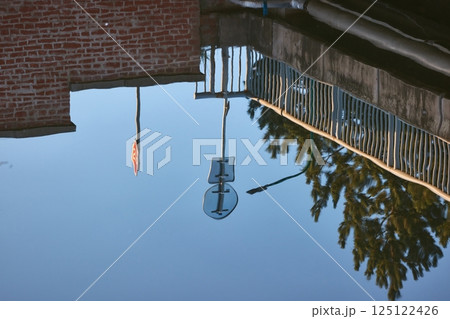 Water surface reflecting a street above 125122426